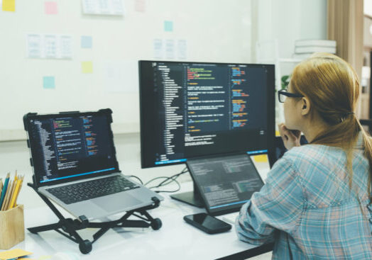 Programmer is coding and programming software. business woman working on computer in the office.